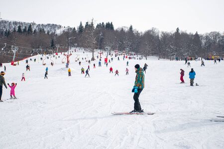 Bakuriani, Georgia February 15, 2020 - Skiers skiing climb a yoke on a mountain. Light skiing track in Bakurianiのeditorial素材