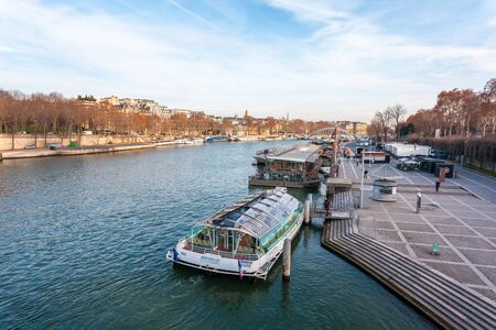 Paris, France - January 16, 2019: view on the Senna river with bridge and ship. Travel.のeditorial素材