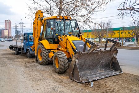 Tbilisi, Georgia - January 20, 2020: Grader and Excavator Construction Equipment Tractor. Transport.のeditorial素材