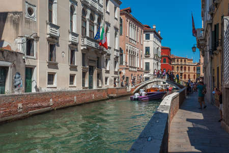 Venice, Italy - August 16, 2018: View of narrow Canal with boats and gondolas in Veniceのeditorial素材