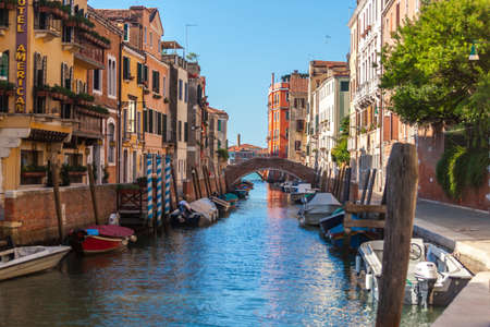 Venice, Italy - August 16, 2018: View of narrow Canal with boats and gondolas in Veniceのeditorial素材