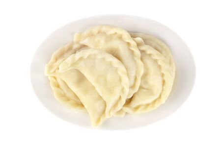 Plate with boiled varenyky, vareniki on white background. Foodの写真素材