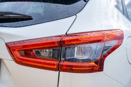 Detail of rear light on a modern white car. new right led rear brake light by night