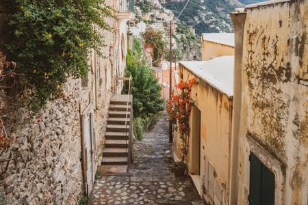 Typical narrow street and colorful houses in city of Positano, Amalfi coast, Italyの写真素材
