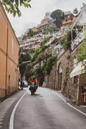 Typical narrow street and colorful houses in city of Positano, Amalfi coast, Italyの写真素材