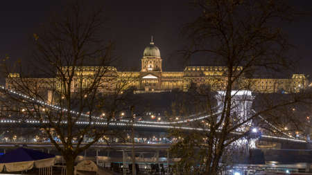 Budapest, Hungary - November 10, 2018: Buda Castle by the Danube river illuminated at night, travelのeditorial素材