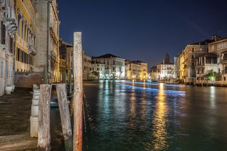 Grand Canal with gondolas at night, Venice, Italy. It is one of the main tourist attractions of Venice