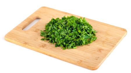 chopped parsley leaf on wooden a board isolated on white background, vegetableの写真素材