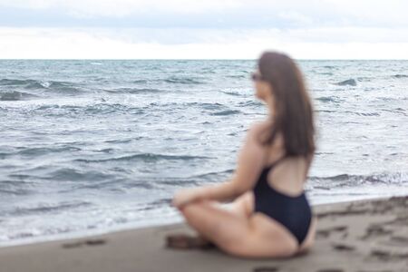Relaxed young woman laying on sandy beach, resortの写真素材