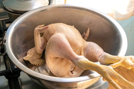 Raw chicken in a metal bowl to clean and prepare food, meatの写真素材