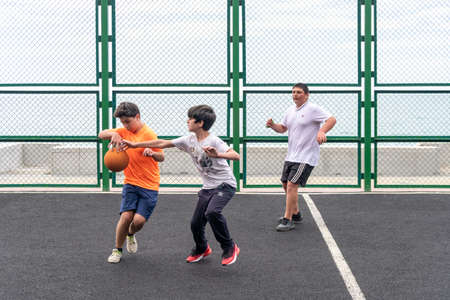 Kobuleti, Georgia - 1 June, 2020: children play basketball on the playground, sportのeditorial素材