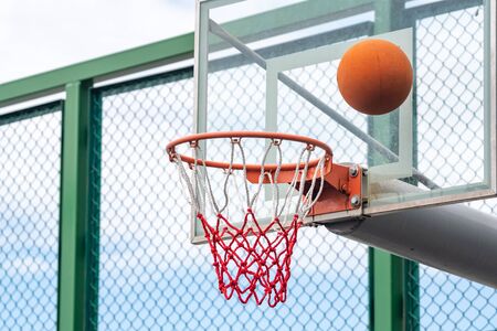 Basketball ring with a net and ball, outdoor playgroundの写真素材
