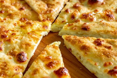 Traditional Georgian bread - khachapuri on the wooden board