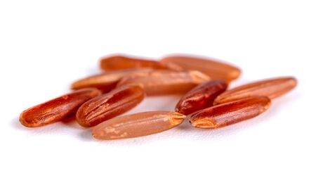Macro shot of red rice isolated on white background, healthy food