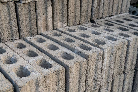 stacks of gray concrete blocks on the ground, industry
