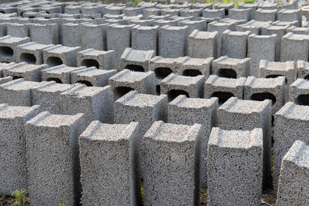 stacks of gray concrete blocks on the ground, industry