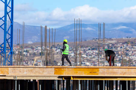Tbilisi, Georgia - 23 November, 2020: Construction workers work on high rise buildings, architecture
