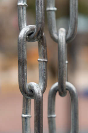 Strong shiny silver chain, outdoors, park background