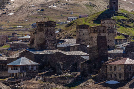 View of the Ushguli village at the foot of Mt. Shkhara. Picturesque and gorgeous scene. Rock towers...