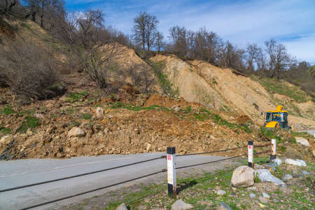 The tractor clears the road from a landslide. Svaneti, Georgia