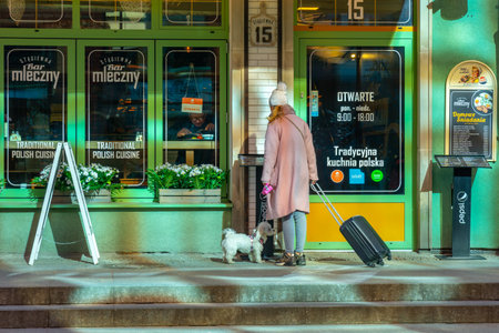 Gdansk, Poland - 11 March, 2022: Tourist with a small dog at the entrance to a bar in Gdansk. Travelのeditorial素材