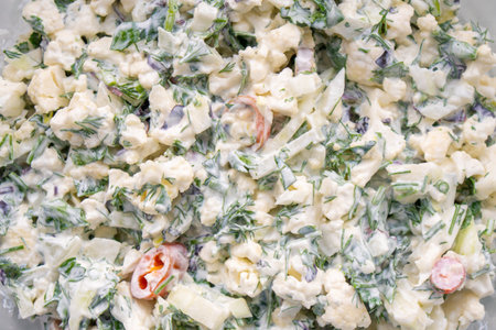 Cauliflower salad, lots of greens and other vegetables with sour cream. Healthy foodの写真素材