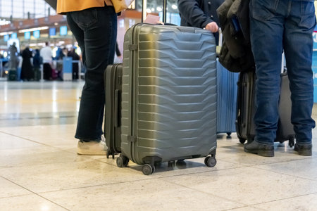Passengers with suitcases waiting for a plane in an airport waiting area. Passengers with suitcases waiting for a plane in an airport waiting area. Travelの写真素材