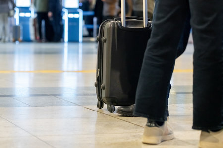 Passengers with suitcases waiting for a plane in an airport waiting area. Passengers with suitcases waiting for a plane in an airport waiting area. Travelの写真素材