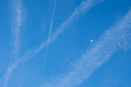 The moon and the trace of the plane are visible in the sky. Backgroundの写真素材