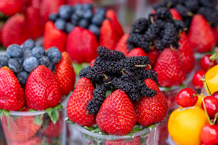 Assorted containers of berries for sale at a market. Healthy fruitsの写真素材