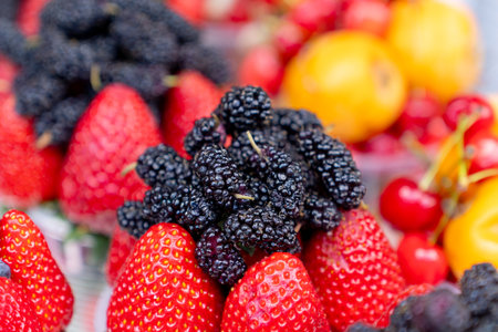 Assorted containers of berries for sale at a market. Healthy fruitsの写真素材