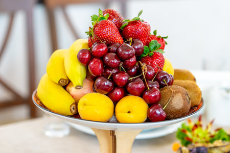 Raw fruits berries assortment platter on the plate, fresh foodの写真素材