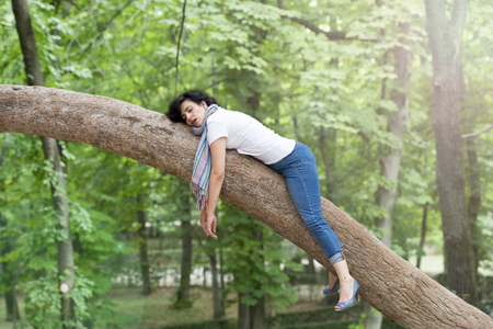 pretty woman sleeping in a tree after being over worked and having trouble sleepingの写真素材