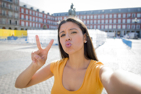 attractive latin woman twenties happy and excited taking a selfie in Plaza Major.の写真素材