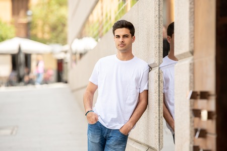 Outdoor portrait of modern trendy handsome caucasian young man in the city. Urban backgroundの写真素材
