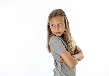 Portrait of angry, sad and depressed little blonde girl isolated on white background. Children's face emotions conceptの写真素材
