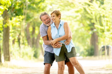 Happy smiling senior couple in love, relaxing, dancing and having fun in the park. Being together...