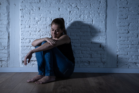 Young devastated depressed woman crying sad feeling hurt suffering depression in sadness emotion in pain and desperate expression. loneliness, depression and heartbroken conceptの写真素材