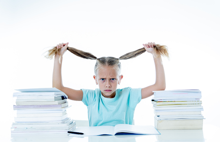 Beautiful school girl trying to study having too many homework that It's driving her crazy in motivation low performance children education concept isolated on white backgroundの写真素材