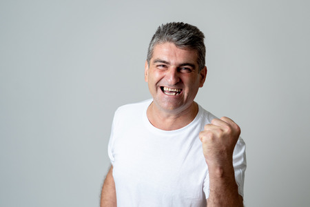 Man rejoices in achieving his goal, wining the lottery or having great success in face expression...