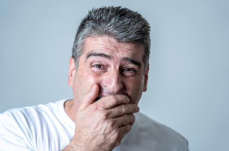Portrait of a 40s 50s man in shock with a scared expression on his face making frightened gestures in human emotions feelings and facial expression concept isolated on grey background.の写真素材