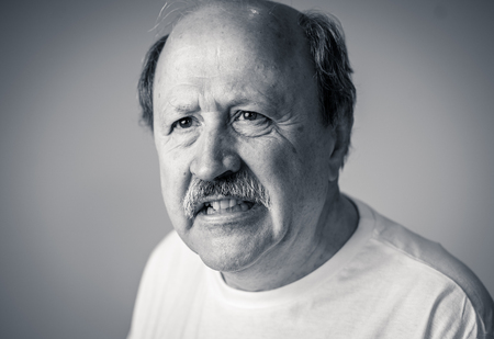 Close up portrait of senior man looking confused and lost suffering from dementia, memory loss or...