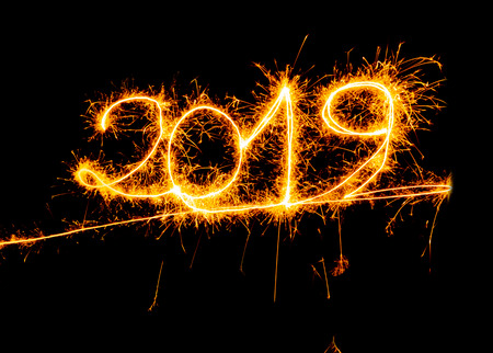 Happy New Year 2019 beautiful shining golden numbers written with sparkle fireworks isolated on...