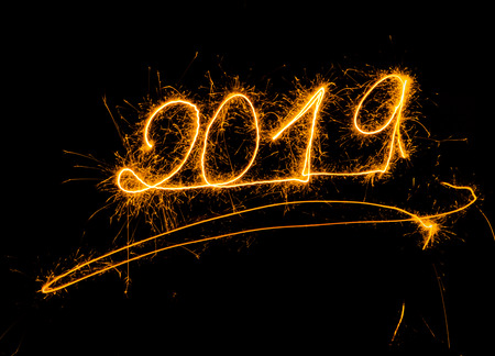 Happy New Year 2019 beautiful shining golden numbers written with sparkle fireworks isolated on black background copy space in Christmas holidays and New Year celebration and Greetings card designs.の写真素材