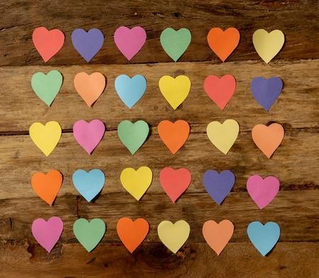 Colorful hearts on wooden vintage background in Happy Saint Valentines day theme decorations, greetings card design and love celebration concept.の写真素材