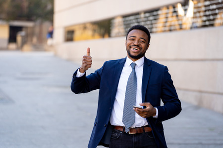 Half length body portrait of confident mature handsome african american CEO businessman entrepreneur in stylish suit outdoors in city street urban background. In People and Creative Business success.の写真素材