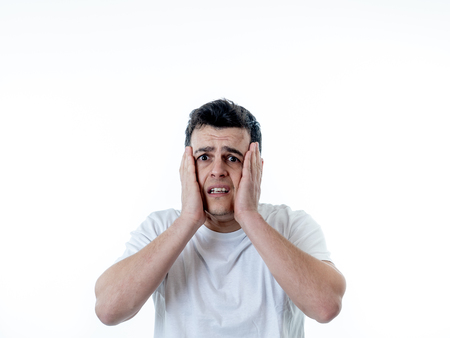 Portrait of young man in shock with a scared face expression making frightened gestures in People, human emotions, feelings and horror facial expression concept. Isolated on white background.の写真素材