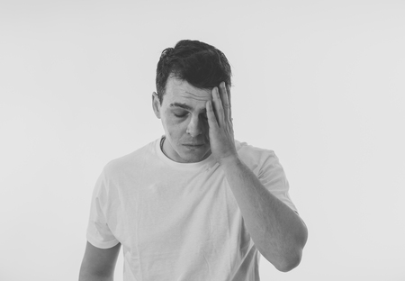 Close up portrait of attractive sad depressed man suffering depression feeling sorrow and emotional pain in people, human emotions face expressions and depression. Isolated on white background.の写真素材