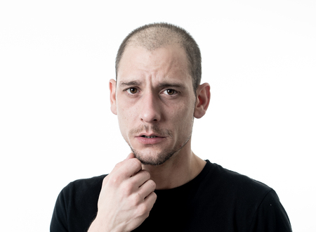 People portraits of human emotions and facial expressions. Young adult man in pain and depression...