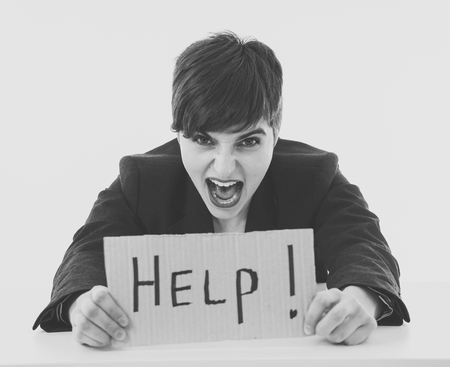 Beautiful business woman feeling overwhelmed and desperate asking for help looking frustrated and upset isolated in white background. In psychological Stress in working woman and frustration concept.の写真素材